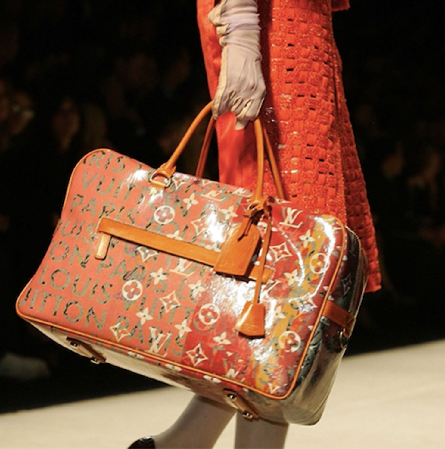 Models hold Louis Vuitton bags designed by Richard Prince at the